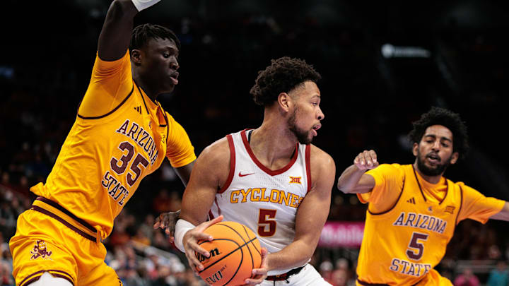 Mar 11, 2026; Kansas City, MO, USA; Iowa State Cyclones forward Joshua Jefferson (5) protects the ball from Arizona State Sun Devils center Massamba Diop (35) during the first half at T-Mobile Center. Mandatory Credit: William Purnell-Imagn Images