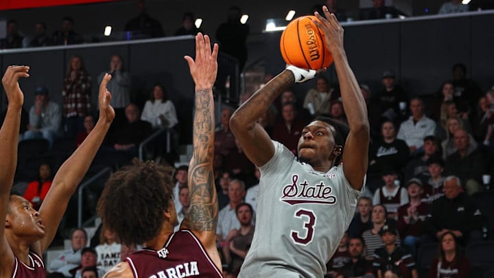 Feb 18, 2025; Starkville, Mississippi, USA; Mississippi State Bulldogs forward KeShawn Murphy (3) shoots against Texas A&M Aggies forward/center Pharrel Payne (21) and forward Andersson Garcia (11) during the second half at Humphrey Coliseum. Mandatory Credit: Petre Thomas-Imagn Images
