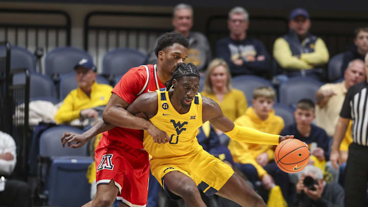Jan 7, 2025; Morgantown, West Virginia, USA; West Virginia Mountaineers center Eduardo Andre (0) backs down Arizona Wildcats forward Tobe Awaka (30) during the second half at WVU Coliseum. Mandatory Credit: Ben Queen-Imagn Images