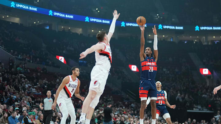 Mar 17, 2025; Portland, Oregon, USA; Washington Wizards power forward Alex Sarr (20) shoots over Portland Trail Blazers center Donovan Clingan (23) during the first half at Moda Center. Mandatory Credit: Soobum Im-Imagn Images
