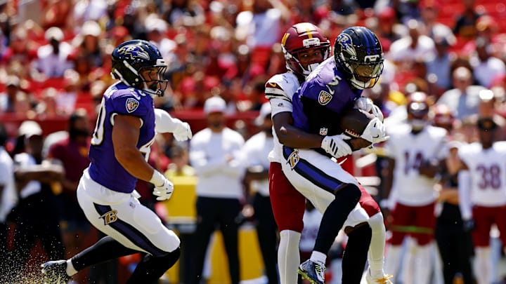 Aug 23, 2025; Landover, Maryland, USA; Baltimore Ravens cornerback Jalyn Armour-Davis (5) makes an interception on a pass intended for Washington Commanders wide receiver K.J. Osborn (13) during the second quarter at Northwest Stadium. Mandatory Credit: Peter Casey-Imagn Images