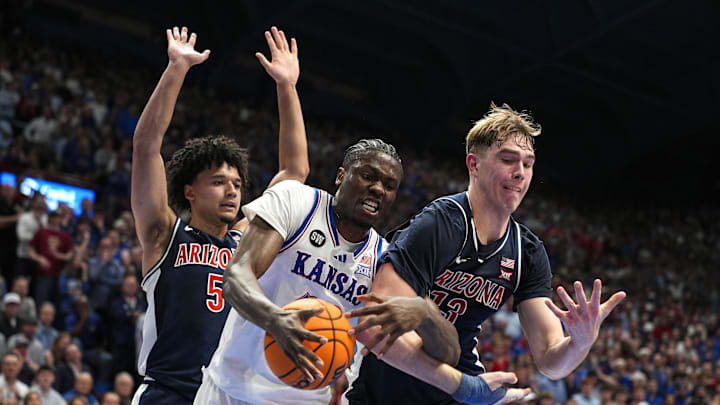 Feb 9, 2026; Lawrence, Kansas, USA; Kansas Jayhawks forward Flory Bidunga (40) and Arizona Wildcats center Motiejus Krivas (13) fight for a rebound during the second half at Allen Fieldhouse. Mandatory Credit: Jay Biggerstaff-Imagn Images Feb 9, 2026; Lawrence, Kansas, USA; Kansas Jayhawks forward Flory Bidunga (40) and Arizona Wildcats center Motiejus Krivas (13) fight for a rebound during the second half at Allen Fieldhouse. Mandatory Credit: Jay Biggerstaff-Imagn Images