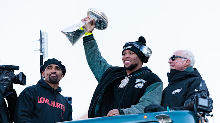 Feb 14, 2025; Philadelphia, PA, USA; Philadelphia Eagles running back Saquon Barkley (26) lifts the Lombardi Trophy during the Super Bowl LIX championship parade and rally. Mandatory Credit: Caean Couto-Imagn Images