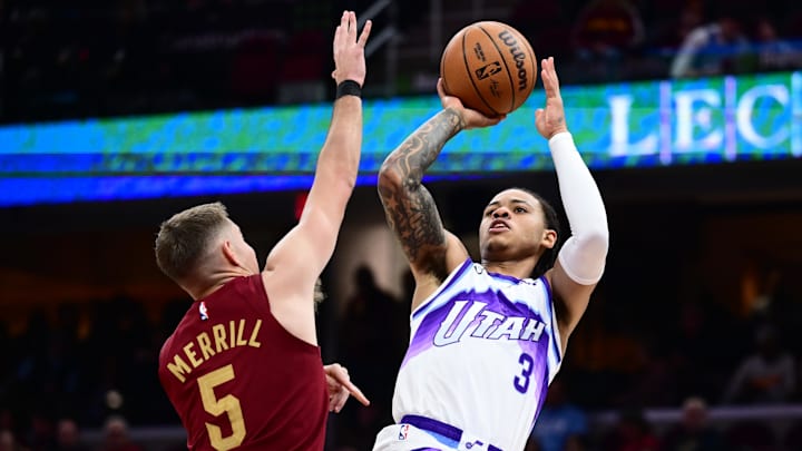 Jan 12, 2026; Cleveland, Ohio, USA; Utah Jazz guard Keyonte George (3) shoots over the defense of Cleveland Cavaliers guard Sam Merrill (5) during the second half at Rocket Arena. Mandatory Credit: Ken Blaze-Imagn Images