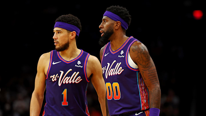 Feb 25, 2024; Phoenix, Arizona, USA; Phoenix Suns guard Devin Booker (1) and forward Royce O'Neale