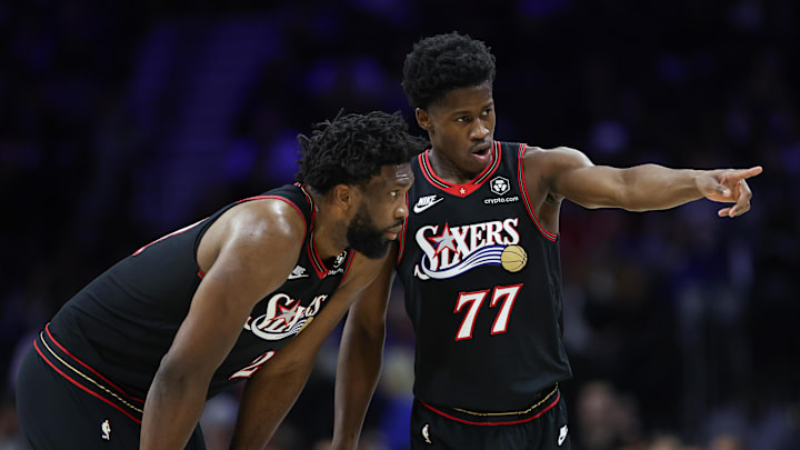 Dec 4, 2025; Philadelphia, Pennsylvania, USA; Philadelphia 76ers guard VJ Edgecombe (77) talks with center Joel Embiid (21) during the second quarter of a game against the Golden State Warriors at Xfinity Mobile Arena. Mandatory Credit: Bill Streicher-Imagn Images