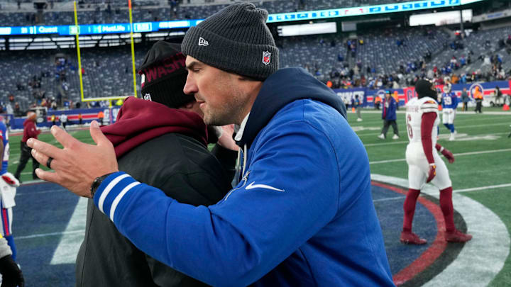 New York Giants Head Coach, Mike Kafka hugs Washington Commanders head coach, Dan Quinn, after the game, Sunday, December 14, 2025. The Commanders were victorious in East Rutherford, 29-21.