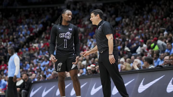 Dec 20, 2024; Cincinnati, Ohio, USA;  Cincinnati Bearcats guard Day Day Thomas (1) talks with head coach Wes Miller in the game against the Dayton Flyers in the second half at Heritage Bank Center. Mandatory Credit: Aaron Doster-Imagn Images