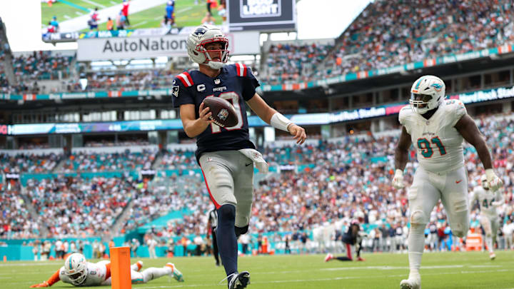 New England Patriots quarterback Drake Maye (10) runs into the end zone for a touchdown against the Miami Dolphins in the third quarter at Hard Rock Stadium.