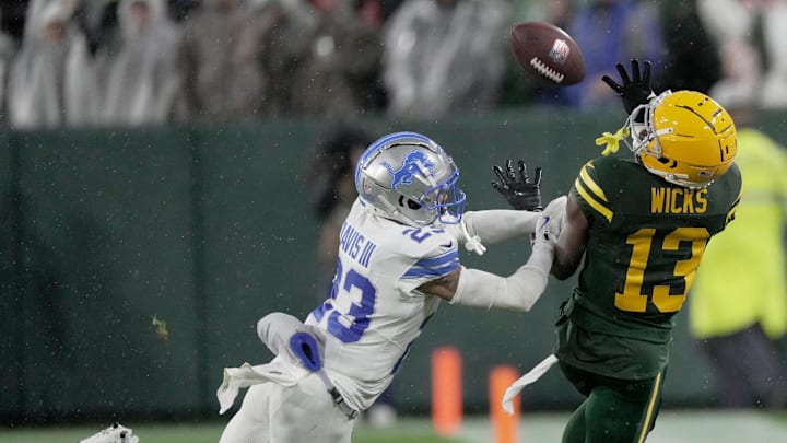 Green Bay Packers wide receiver Dontayvion Wicks (13) is unable to make a catch inbounds against Lions cornerback Carlton Davis III on Sunday at Lambeau Field.