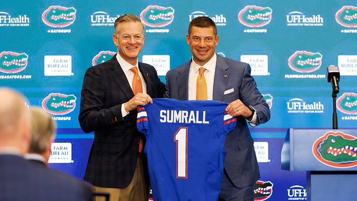Dec 1, 2025; Gainesville, FL, USA; Florida Gators athletic director Scott Stricklin and Florida Gators head coach Jon Sumrall poses with a Florida Gators jersey during the press conference at the Heavener Football Training Center at the University of Florida. Mandatory Credit: Matt Pendleton-Imagn Images
