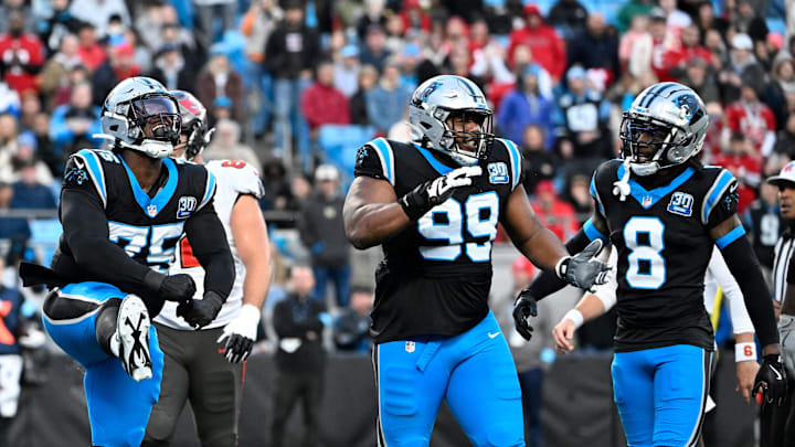 Dec 1, 2024; Charlotte, North Carolina, USA;  Carolina Panthers defensive tackle DeShawn Williams (75) and defensive tackle Shy Tuttle (99) and cornerback Jaycee Horn (8) react in the first quarter at Bank of America Stadium. Mandatory Credit: Bob Donnan-Imagn Images
