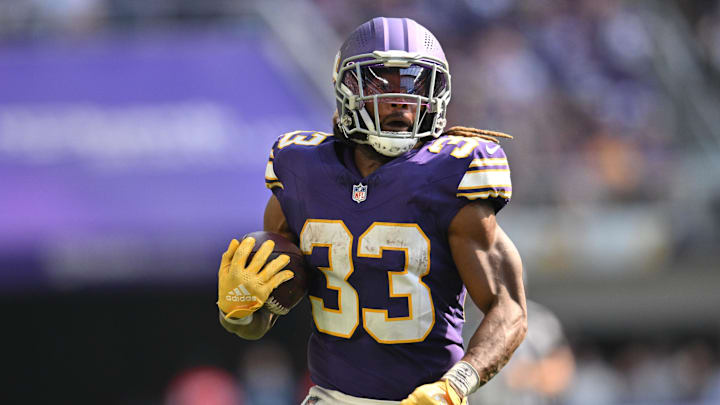 Sep 22, 2024; Minneapolis, Minnesota, USA; Minnesota Vikings running back Aaron Jones (33) runs the ball against the Houston Texans during the fourth quarter at U.S. Bank Stadium. Mandatory Credit: Jeffrey Becker-Imagn Images