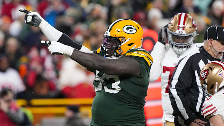 Nov 24, 2024; Green Bay, Wisconsin, USA;  Green Bay Packers defensive lineman T.J. Slaton (93) celebrates following a turnover during the fourth quarter against the San Francisco 49ers at Lambeau Field. Mandatory Credit: Jeff Hanisch-Imagn Images