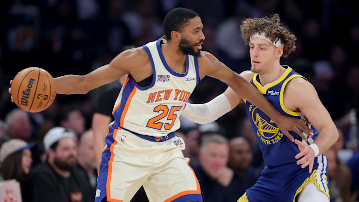 Mar 15, 2026; New York, New York, USA; New York Knicks guard Mikal Bridges (25) controls the ball against Golden State Warriors guard Brandin Podziemski (2) during the first quarter at Madison Square Garden. Mandatory Credit: Brad Penner-Imagn Images