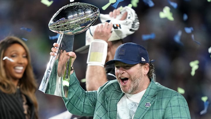 Feb 8, 2026; Santa Clara, CA, USA; Seattle Seahawks general manager John Schneider celebrates with the Vince Lombardi trophy on the podium after defeating the New England Patriots in Super Bowl LX at Levi's Stadium. 