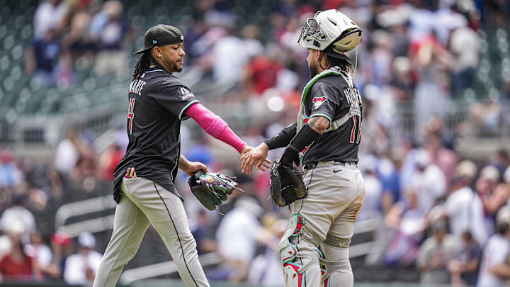 Jun 5, 2025; Cumberland, Georgia, USA; Arizona Diamondbacks second baseman Ketel Marte (4) reacts with catcher Jose Herrera (11) after the Diamondbacks defeated the Atlanta Braves at Truist Park. Mandatory Credit: Dale Zanine-Imagn Images Jun 5, 2025; Cumberland, Georgia, USA; Arizona Diamondbacks second baseman Ketel Marte (4) reacts with catcher Jose Herrera (11) after the Diamondbacks defeated the Atlanta Braves at Truist Park. Mandatory Credit: Dale Zanine-Imagn Images