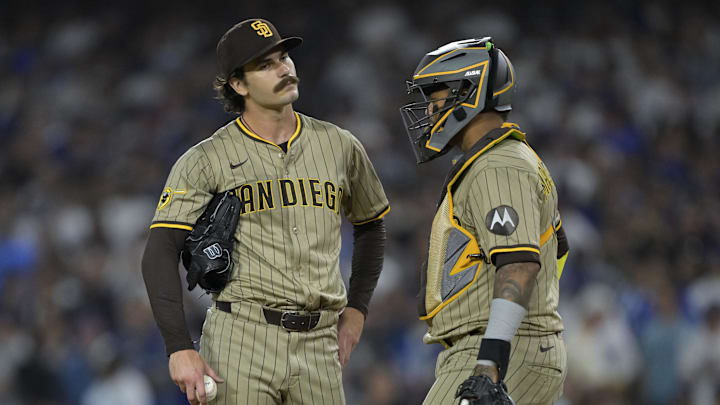 Jun 16, 2025; Los Angeles, California, USA; San Diego Padres starting pitcher Dylan Cease (84) and catcher Martin Maldonado (15) during a mound visit in the fourth inning against the Los Angeles Dodgers at Dodger Stadium. Mandatory Credit: Jayne Kamin-Oncea-Imagn Images