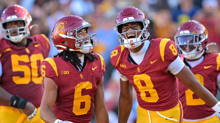 Oct 11, 2025; Los Angeles, California, USA;  USC Trojans wide receiver Ja'Kobi Lane (8) is congratulated by wide receiver Makai Lemon (6) after catching a touchdown pass in the first half at United Airlines Field at the Los Angeles Memorial Coliseum. Mandatory Credit: Jayne Kamin-Oncea-Imagn Images