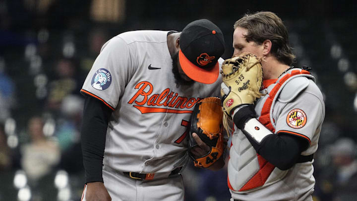 May 20, 2025; Milwaukee, Wisconsin, USA; Baltimore Orioles catcher Adley Rutschman (35) talks with pitcher Félix Bautista (74) on the mound against the Milwaukee Brewers in the eighth inning at American Family Field. 