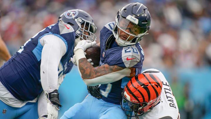 Tennessee Titans running back Tony Pollard (20) is stopped by Cincinnati Bengals safety Jordan Battle (27) during the third quarter at Nissan Stadium in Nashville, Tenn., Sunday, Dec. 15, 2024.
