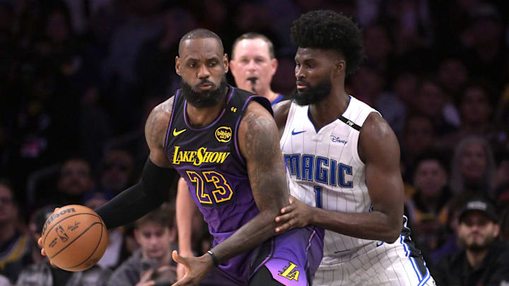 Nov 21, 2024; Los Angeles, California, USA; Los Angeles Lakers forward LeBron James (23) is defended by Orlando Magic forward Jonathan Isaac (1) in the first half at Crypto.com Arena. Mandatory Credit: Jayne Kamin-Oncea-Imagn Images