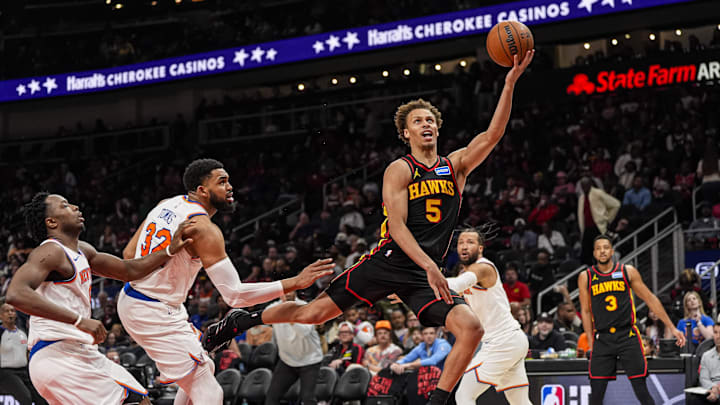 Apr 6, 2026; Atlanta, Georgia, USA; Atlanta Hawks guard Dyson Daniels (5) goes to the basket past New York Knicks center Karl-Anthony Towns (32) during the second half at State Farm Arena. Mandatory Credit: Dale Zanine-Imagn Images