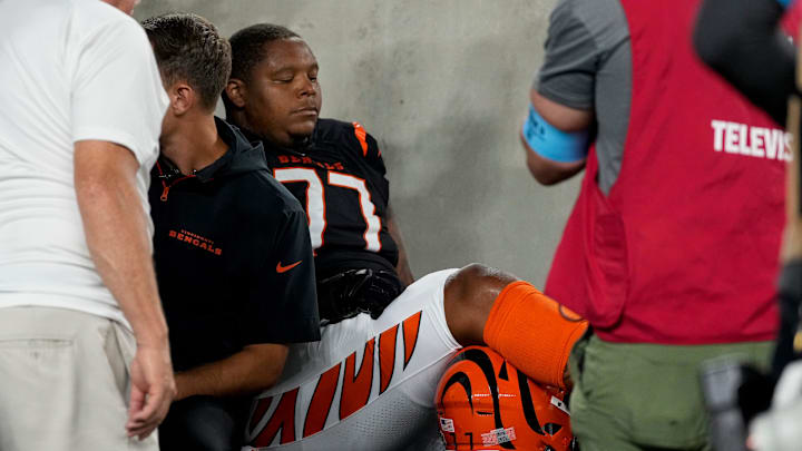 Cincinnati Bengals offensive tackle Trent Brown (77) is assisted off the field by the medical staff in the second quarter of the NFL Week 3 game between the Cincinnati Bengals and the Washington Commanders at Paycor Stadium in downtown Cincinnati on Monday, Sept. 23, 2024. The Commanders led 21-13 at halftime. Cincinnati Bengals offensive tackle Trent Brown (77) is assisted off the field by the medical staff in the second quarter of the NFL Week 3 game between the Cincinnati Bengals and the Washington Commanders at Paycor Stadium in downtown Cincinnati on Monday, Sept. 23, 2024. The Commanders led 21-13 at halftime.