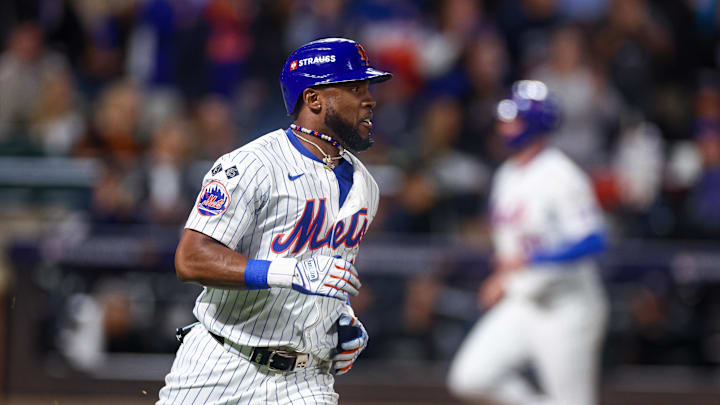 New York Mets right fielder Starling Marte (6) hits an RBI single during the eighth inning against the Los Angeles Dodgers during game five of the NLCS for the 2024 MLB playoffs at Citi Field. 