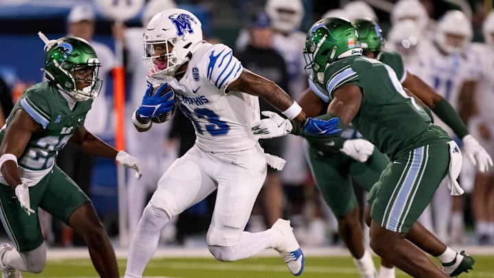Nov 28, 2024; New Orleans, Louisiana, USA; Memphis Tigers running back Greg Desrosiers Jr. (13) breaks away from Tulane Green Wave linebacker Chris Rodgers (4) finishing off the play with a touchdown during the second quarter at Yulman Stadium.