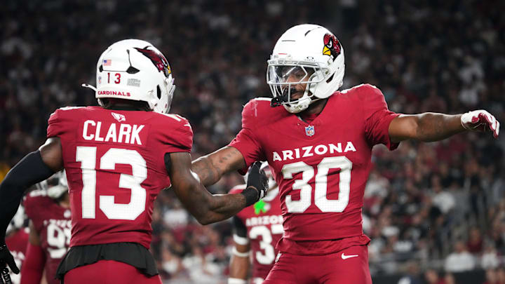 Arizona Cardinals safety Darren Hall (30) celebrates a defensive stop with teammate Kei'Trel Clark (13) against the Las Vegas Raiders at State Farm Stadium in Glendale, on Aug. 23, 2025.