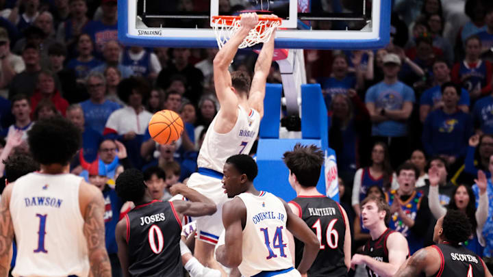 Dec 22, 2025; Lawrence, Kansas, USA; Kansas Jayhawks guard Kohl Rosario (7) dunks the ball against the Davidson Wildcats during the first half of the game at Allen Fieldhouse. Mandatory Credit: Denny Medley-Imagn Images