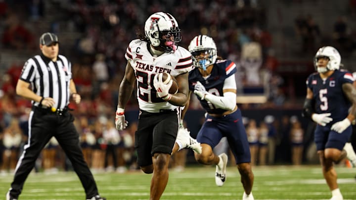 Oct 5, 2024; Tucson, Arizona, USA; Texas Tech Red Raiders running back Tahj Brooks (28) runs with ball while Arizona Wildcats defend during fourth quarter at Arizona Stadium. Mandatory Credit: Aryanna Frank-Imagn Images