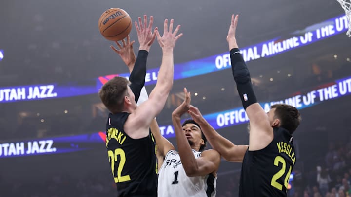 Oct 31, 2024; Salt Lake City, Utah, USA; San Antonio Spurs center Victor Wembanyama (1) passes against defenders Utah Jazz forward Kyle Filipowski (22) and center Walker Kessler (24) during the first quarter at Delta Center. Mandatory Credit: Rob Gray-Imagn Images