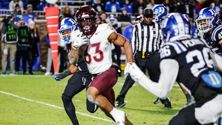 Nov 23, 2024; Durham, North Carolina, USA;  Virginia Tech Hokies running back Bhayshul Tuten (33) runs with the football during the second half of the game against Duke Blue Devils at Wallace Wade Stadium. Mandatory Credit: Jaylynn Nash-Imagn Images