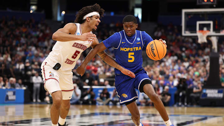 Mar 20, 2026; Tampa, FL, USA; Hofstra Pride guard Cruz Davis (5) drives against Alabama Crimson Tide forward Amari Allen (5) in the second half during a first round game of the men's 2026 NCAA Tournament at Benchmark International Arena. Mandatory Credit: Nathan Ray Seebeck-Imagn Images