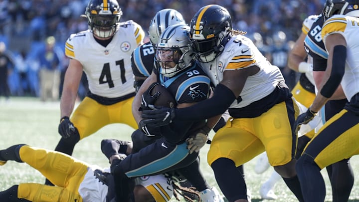 Dec 18, 2022; Charlotte, North Carolina, USA; Carolina Panthers running back Chuba Hubbard (30) is tackled near the end zone by Pittsburgh Steelers defensive tackle Larry Ogunjobi (99) during the first quarter at Bank of America Stadium.