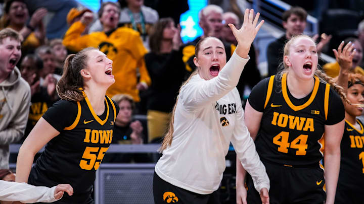 Iowa Hawkeyes guard Teagan Mallegni (55), Iowa Hawkeyes forward AJ Ediger (34) and Iowa Hawkeyes forward Addison O'Grady (44) cheer Thursday, March 6, 2025, in a round two game at the 2025 TIAA Big Ten Women's Basketball Tournament between the Iowa Hawkeyes and the Michigan State Spartans at Gainbridge Fieldhouse in Indianapolis. The Hawkeyes defeated the Spartans, 74-61.
