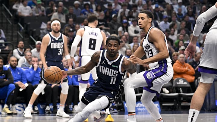 Mar 3, 2025; Dallas, Texas, USA; Dallas Mavericks guard Kyrie Irving (11) drives to the basket past Sacramento Kings forward Keegan Murray (13) during the first quarter at the American Airlines Center. Mandatory Credit: Jerome Miron-Imagn Images