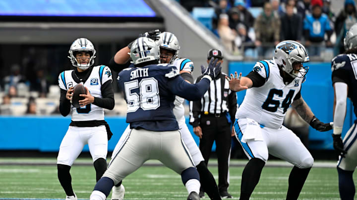 Dec 15, 2024; Charlotte, North Carolina, USA;  Carolina Panthers quarterback Bryce Young (9) looks to pass as Dallas Cowboys defensive tackle Mazi Smith (58) pressures in the first quarter at Bank of America Stadium. Mandatory Credit: Bob Donnan-Imagn Images