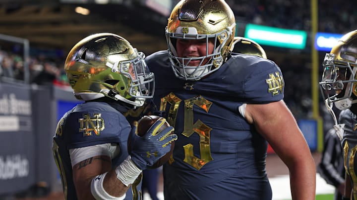 Nov 23, 2024; New York, New York, USA; Notre Dame Fighting Irish running back Aneyas Williams (20) celebrates a rushing touchdown with offensive lineman Sullivan Absher (75) during the second half against the Army Black Knights at Yankee Stadium.