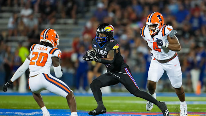 Sep 8, 2023; Lawrence, Kansas, USA; Kansas Jayhawks running back Devin Neal (4) runs the ball against Illinois defensive tackle Jer'Zhan Newton - Jay Biggerstaff/USA TODAY Sports