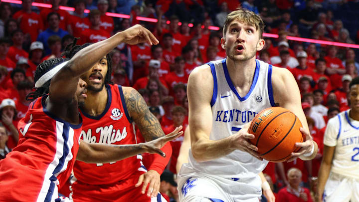 Feb 4, 2025; Oxford, Mississippi, USA; Kentucky Wildcats forward Andrew Carr (7) drives to the basket as Mississippi Rebels guard Jaylen Murray (5) defends during the first half at The Sandy and John Black Pavilion at Ole Miss. Mandatory Credit: Petre Thomas-Imagn Images