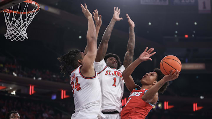 Nov 17, 2024; New York, New York, USA; New Mexico Lobos guard Tru Washington (3) looks to drive past St. John's basketball forward Zuby Ejiofor (24) and guard Kadary Richmond (1) in the first half at Madison Square Garden.
