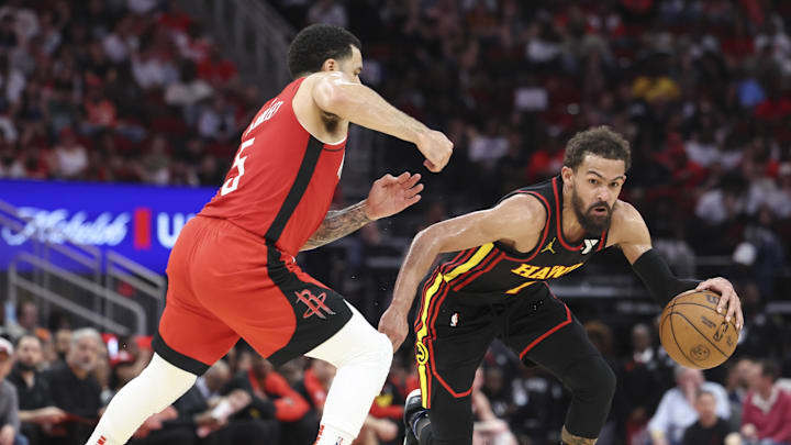 Mar 25, 2025; Houston, Texas, USA; Atlanta Hawks guard Trae Young (11) dribbles the ball as Houston Rockets guard Fred VanVleet (5) defends during the third quarter at Toyota Center. Mandatory Credit: Troy Taormina-Imagn Images