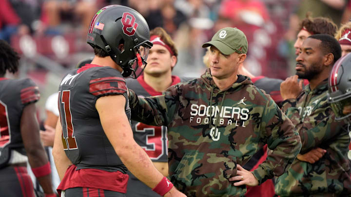 Kevin Johns talks with Oklahoma Sooners quarterback Jackson Arnold (11) before a college football game between the University of Oklahoma Sooners (OU) and the Maine Black Bears at Gaylord Family - Oklahoma Memorial Stadium in Norman, Okla., Saturday, Nov. 2, 2024. Kevin Johns talks with Oklahoma Sooners quarterback Jackson Arnold (11) before a college football game between the University of Oklahoma Sooners (OU) and the Maine Black Bears at Gaylord Family - Oklahoma Memorial Stadium in Norman, Okla., Saturday, Nov. 2, 2024.
