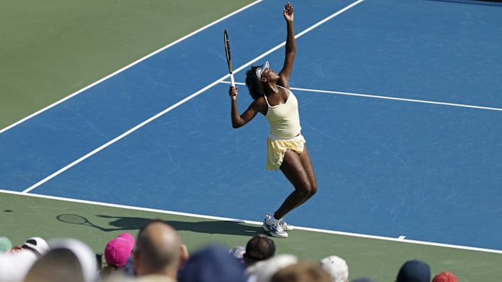 Venus Williams (USA) serves behind partner Hailey Baptiste (USA)(not pictured) against Eugenie Bouchard (CAN) and Clervie Ngounoue (USA) (both not pictured) in a women's doubles match on day one of the Mubadala Citi DC Open at Rock Creek Park Tennis Center. 