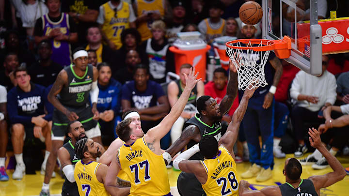 Apr 30, 2025; Los Angeles, California, USA; Minnesota Timberwolves forward Julius Randle (30) shoots against Los Angeles Lakers guard Gabe Vincent (7) guard Luka Doncic (77) and forward Rui Hachimura (28) during the second half in game five of first round for the 2025 NBA Playoffs at Crypto.com Arena. Mandatory Credit: Gary A. Vasquez-Imagn Images