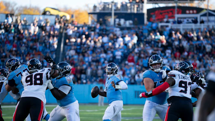 Tennessee quarterback Cam Ward (1) makes a break for the hole in the Houston defensive line during their game at Nissan Stadium in Nashville, Tenn., Sunday, Nov. 16, 2025. The Titans scored a touchdown on the next play and tied the game with a Tennessee place kicker Joey Slye (6) extra point. With about 1:30 to go in the game, Houston moved down the field and kicked a game-winning field goal to run out the clock. The final score: Texans 16 - Titans 13.