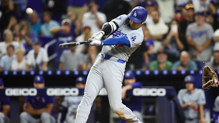 Sep 19, 2024; Miami, Florida, USA; Los Angeles Dodgers designated hitter Shohei Ohtani (17) hits a three-run home run against the Miami Marlins during the ninth inning at loanDepot Park. Mandatory Credit: Sam Navarro-Imagn Images